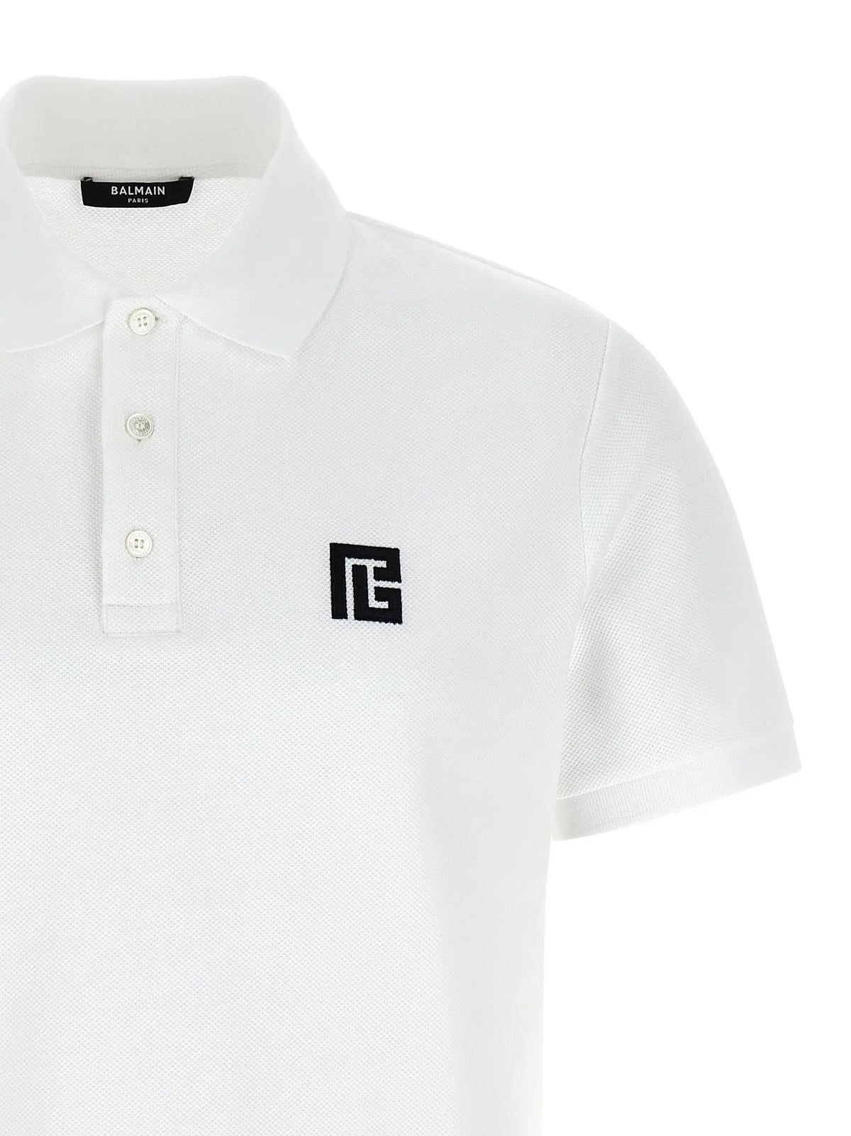 Polo balmain bicolor en coton blanc avec logo brodé noir sur la poitrine et boutons assortis