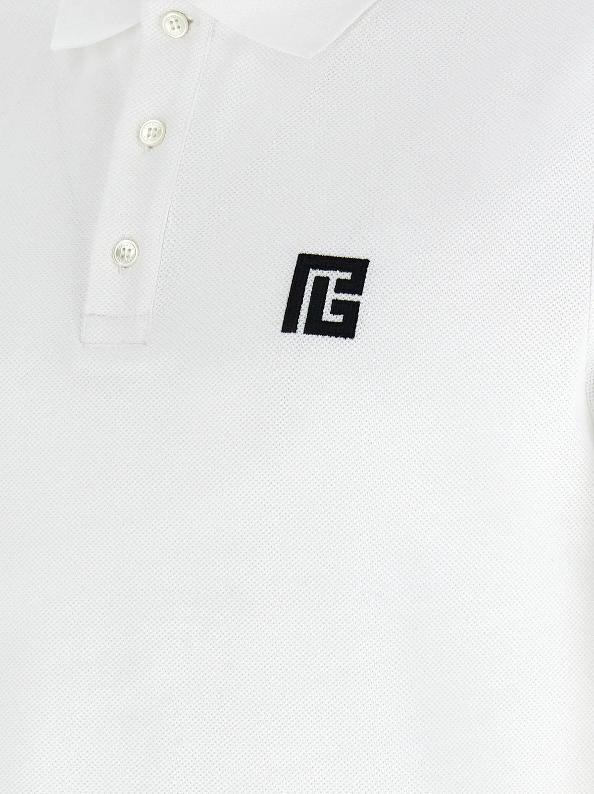 Polo en coton blanc balmain avec logo brodé noir sur la poitrine et boutons blancs