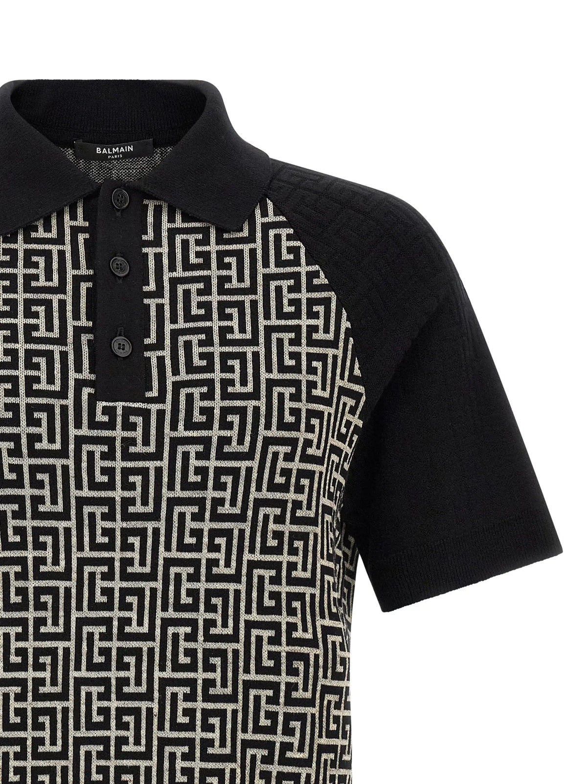 Polo balmain bicolor en coton avec motif géométrique noir et blanc et manches contrastantes noires