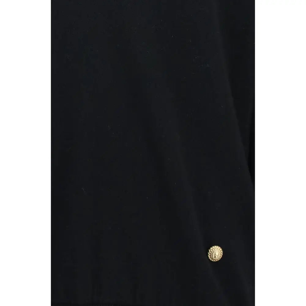 Petit bouton rond doré texturé cousu sur le sweatshirt balmain noir en laine oves aries