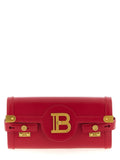 Balmain fuchsia calfskin clutch bag rouge avec fermoir doré et logo emblématique visible sur le devant