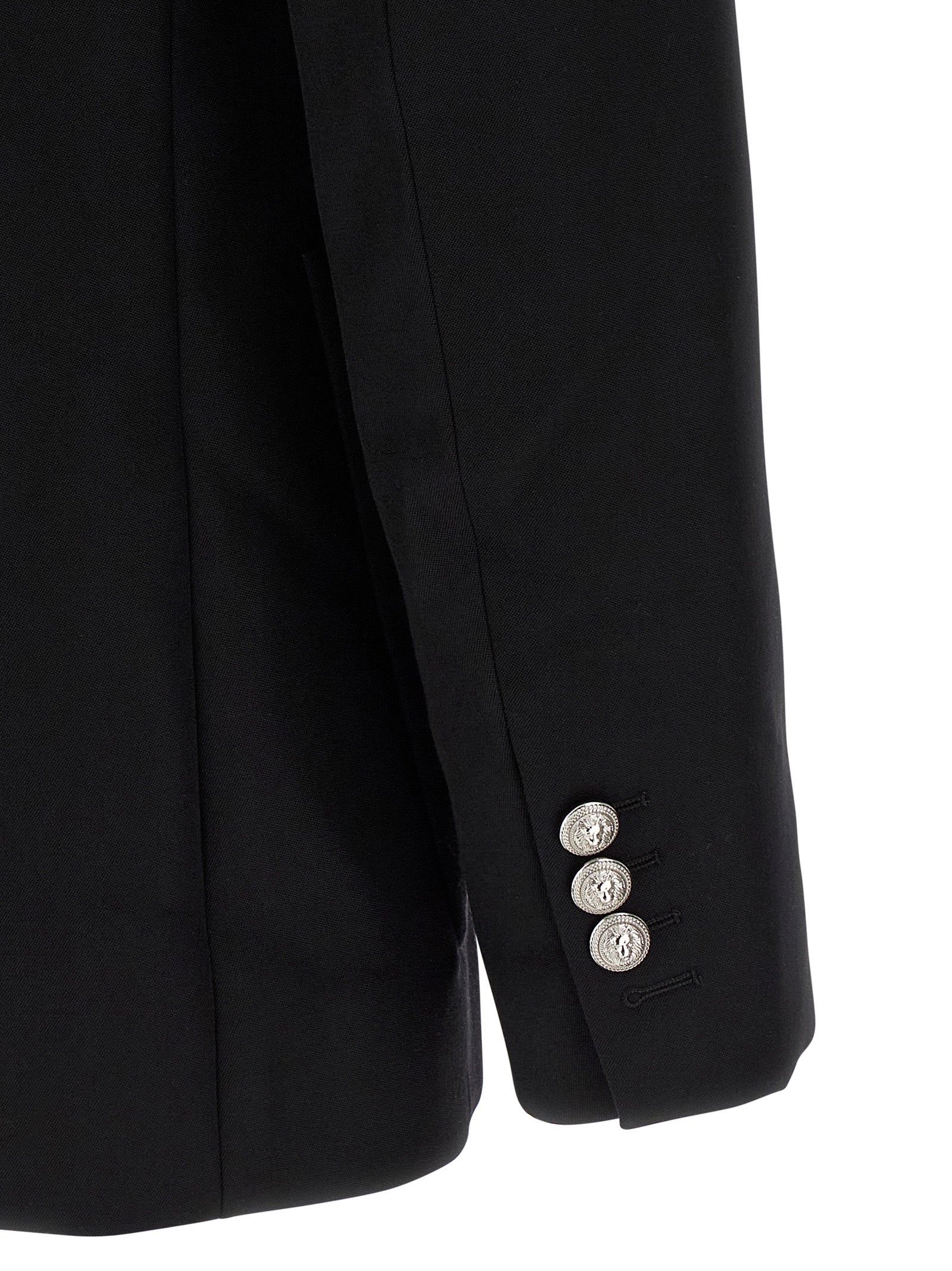 Blazer noir en laine vierge de Balmain, coupe élégante et moderne, porté sur un mannequin.