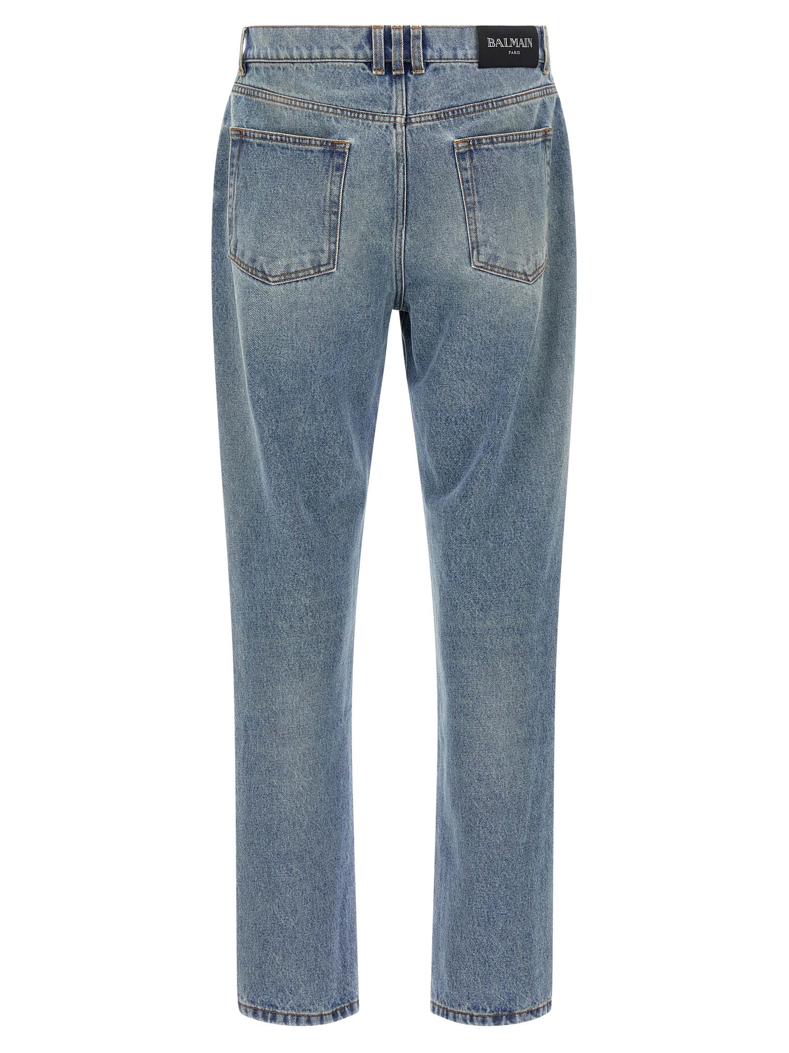Jeans en denim bleu en coton de la marque Balmain, coupe classique et détails de couture visibles.