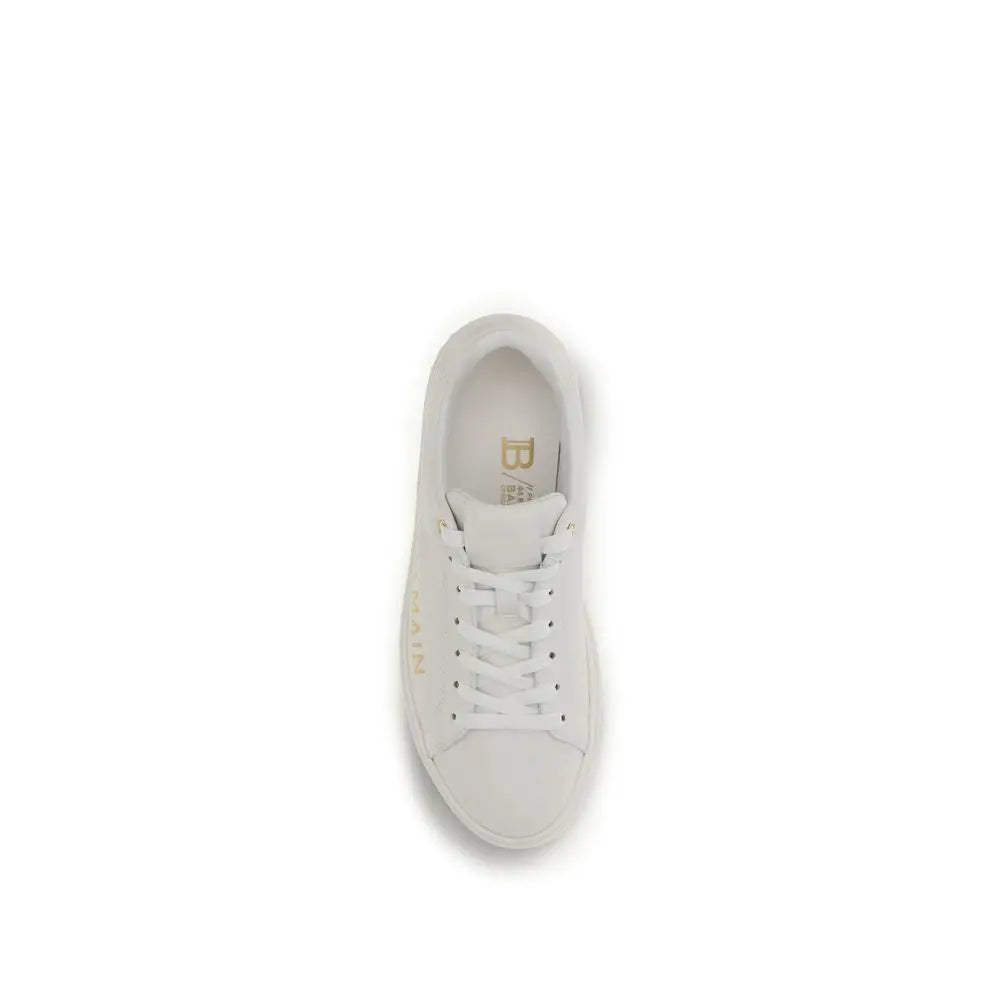 Balmain white calf leather bos taurus low top sneaker en cuir blanc avec détails dorés et branding visible