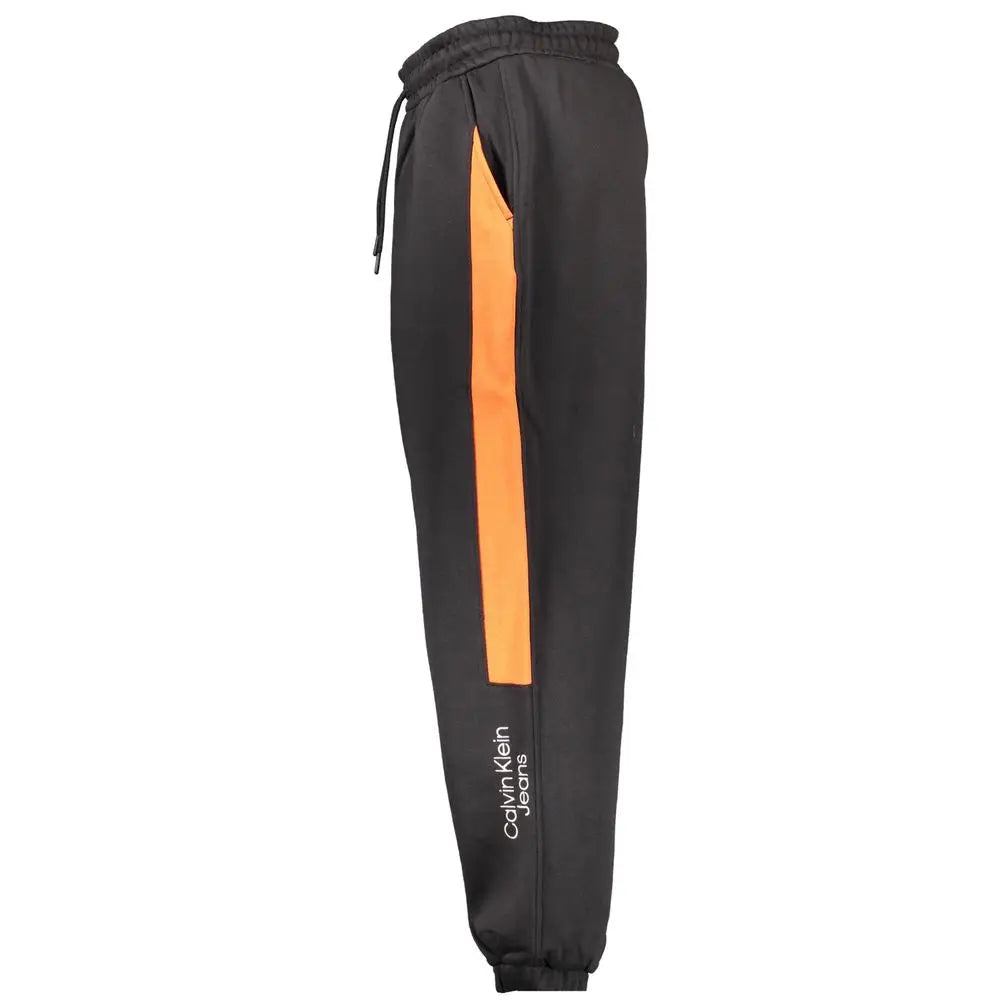 Calvin klein nero cotton sweatpant noir avec bande orange verticale et logo blanc sur la jambe