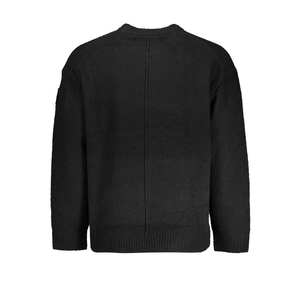 Pull pour homme Calvin Klein en coton noir, doux et confortable, avec logo discret sur la poitrine.