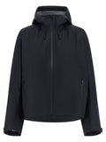 Veste Canada Goose en polyester noir pour femme, coupe-vent et résistante à l'eau, avec capuche et poches pratiques.