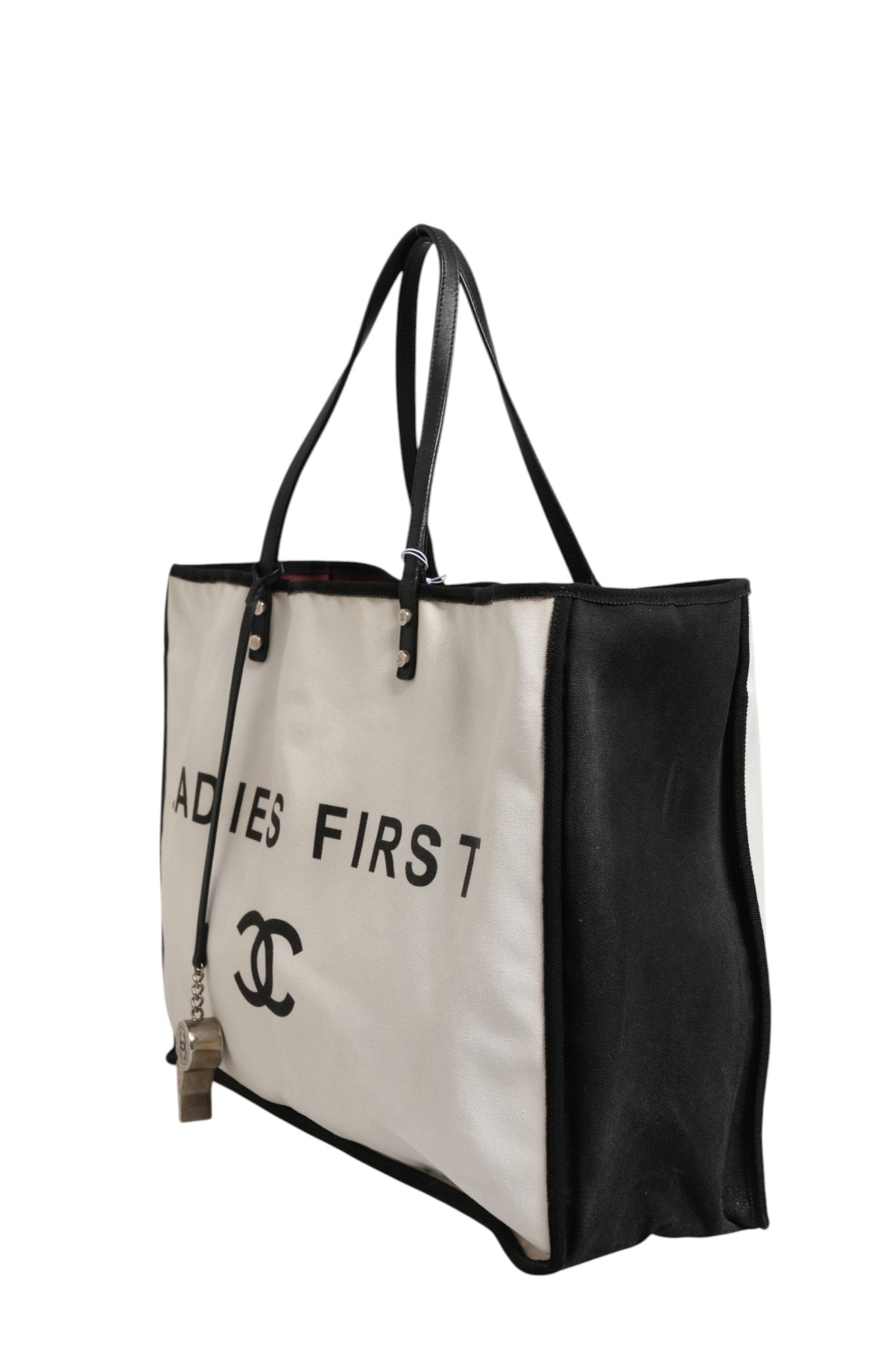 Sac à main Chanel Ladies First, tote en toile blanche et noire, élégant et pratique pour femmes.