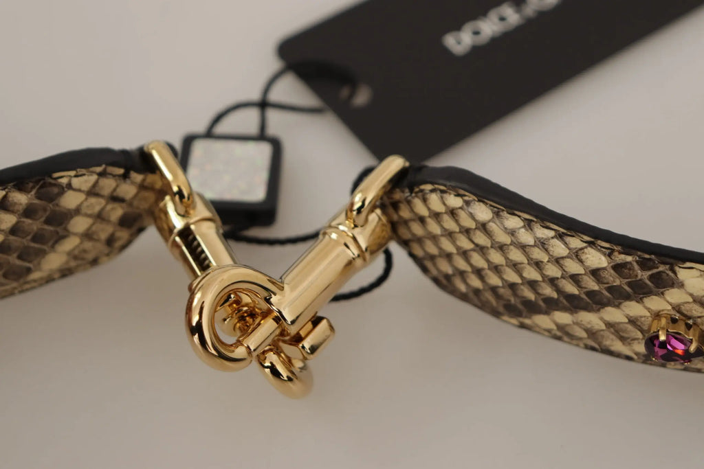 Gold-tone metal clasp on a beige snakeskin-patterned dante gabbana reversible shoulder strap with pink gemstone accent