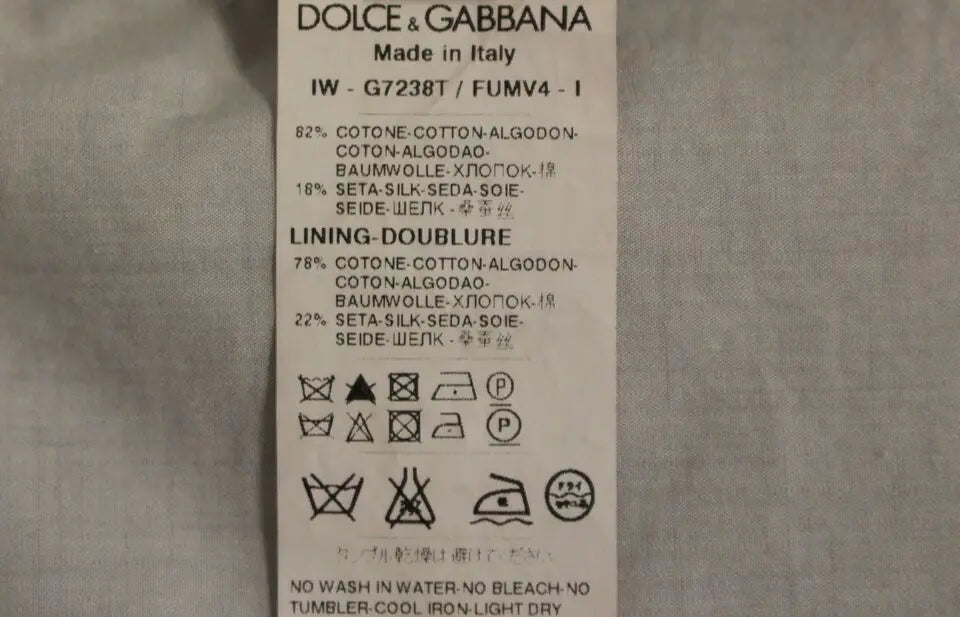 Étiquette de soin blanche dolce & gabbana avec texte noir pour robe beige en mélange de soie formelle gilet