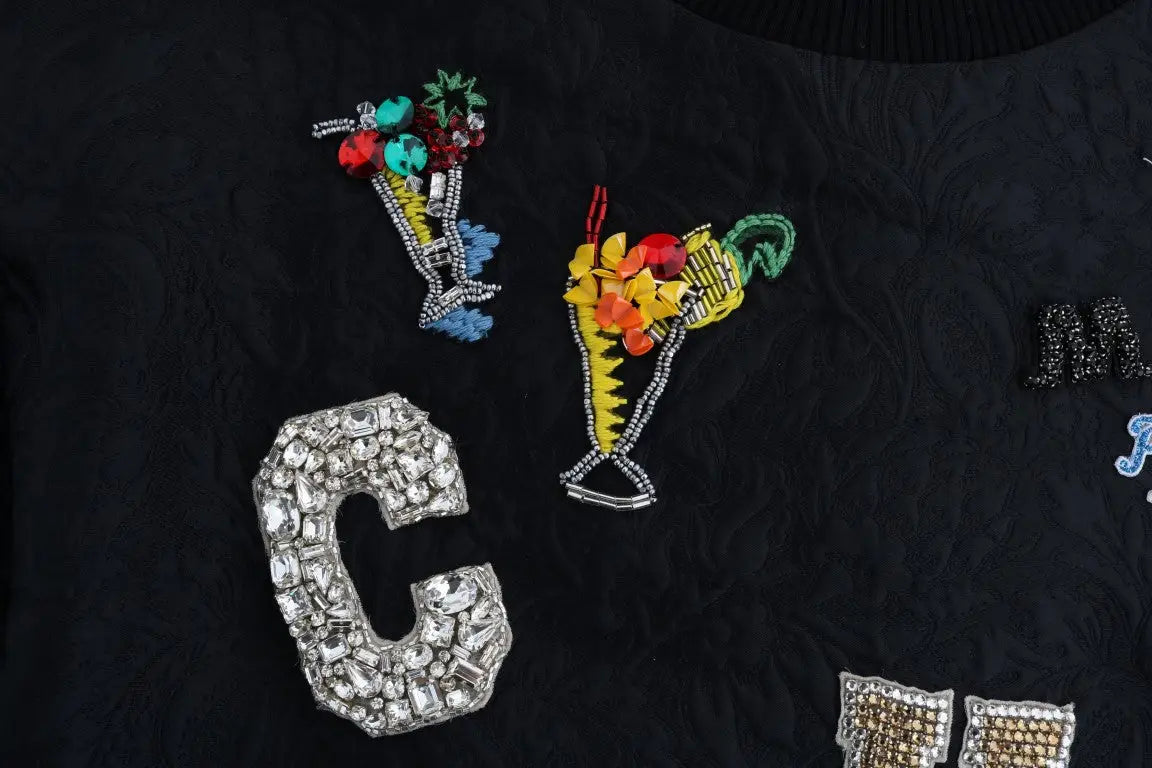 Lettre c en strass argenté étincelant sur tissu noir du pull cocktail crystal brocart dolce & gabbana