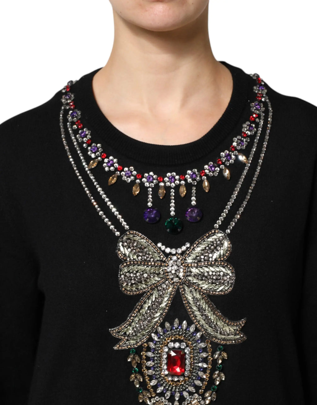 Statement necklace with a large beaded silver bow and colorful gemstones paired with dolce & gabbana black cashmere sweater