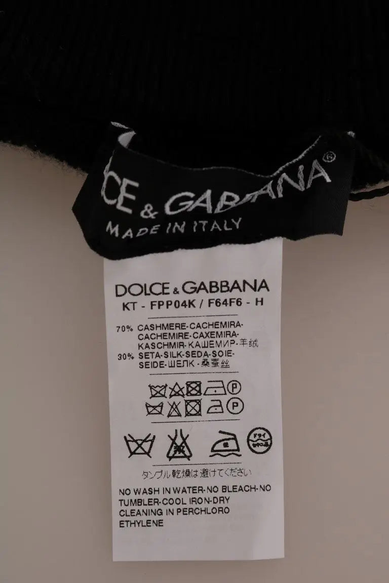 Étiquette noire dolce & gabbana avec instructions d’entretien sur des collants noirs en cachemire soie stretch