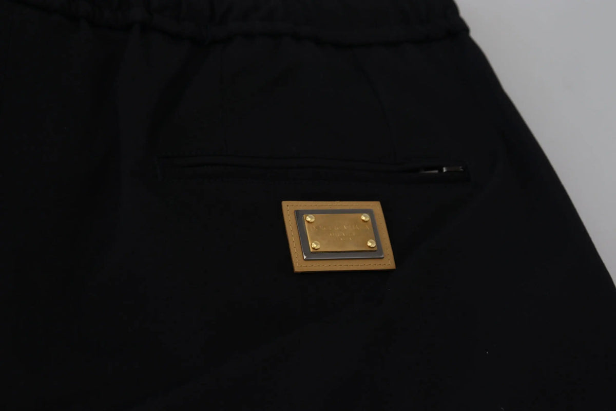 Pantalon noir en coton dolce & gabbana avec taille élastique et patch doré rectangulaire à rivets en laiton