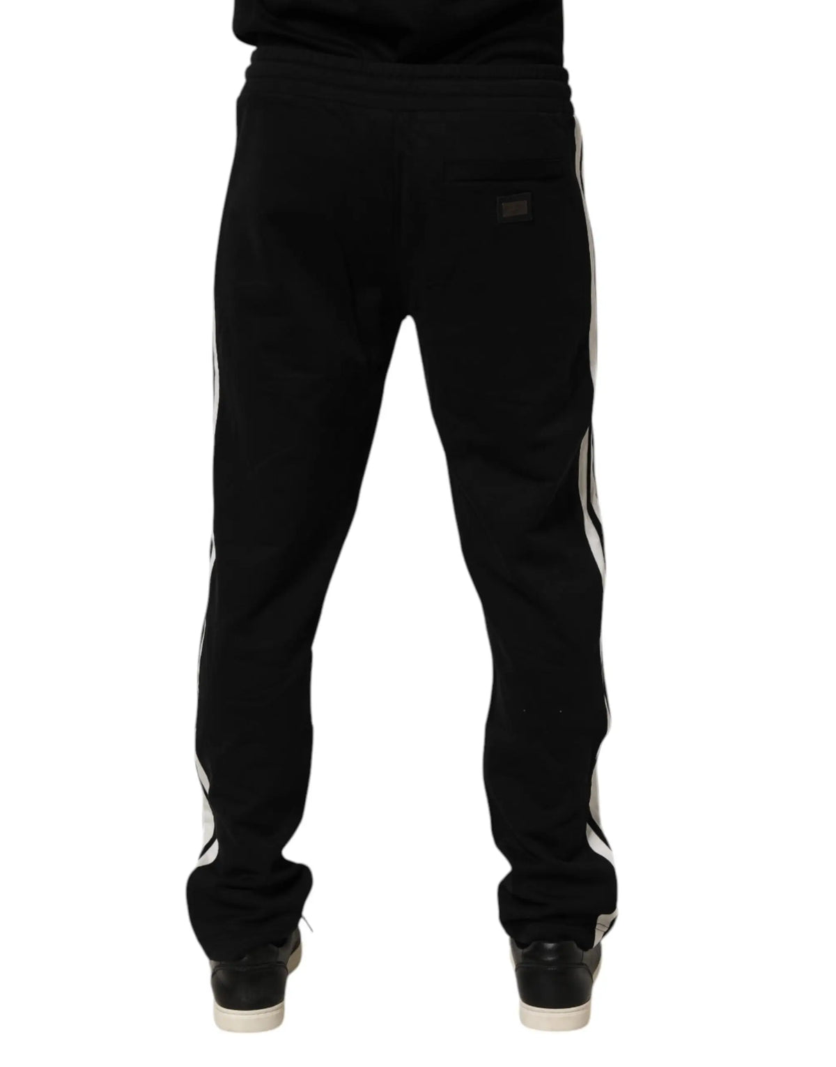 Vue arrière de pantalon de jogging dolce & gabbana noir en coton avec bandes blanches latérales et petit logo noir