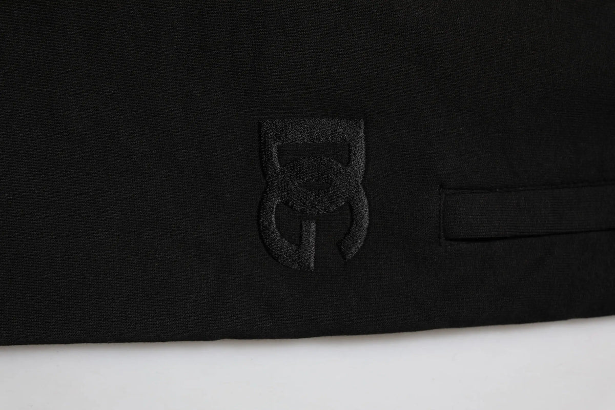 Logo noir brodé sur tissu noir des jogger pants homme dolce & gabbana en coton avec bande logo