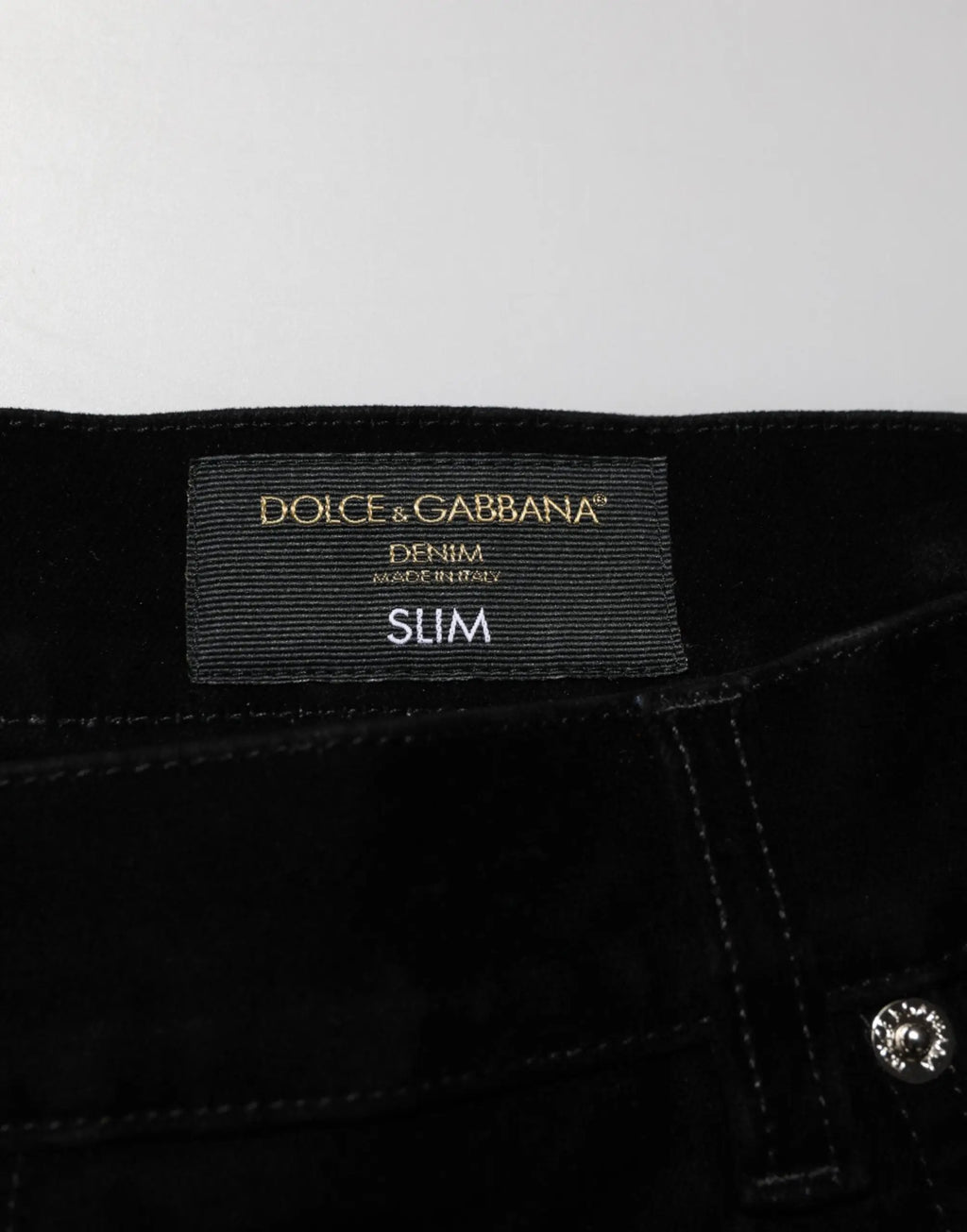 Jean slim fit en denim noir dolce & gabbana en coton avec étiquette côtelée et marquage doré foil
