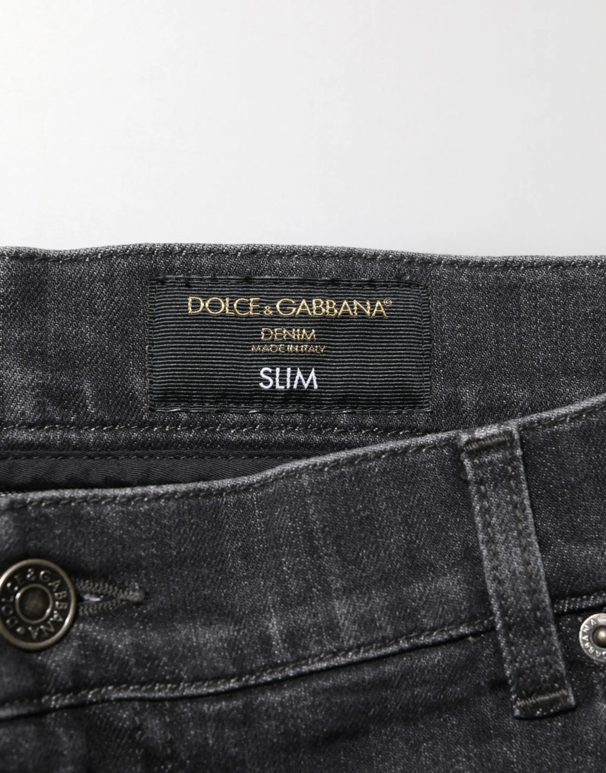 Jean slim fit noir en coton avec déchirures et logo dolce & gabbana brodé en fil doré