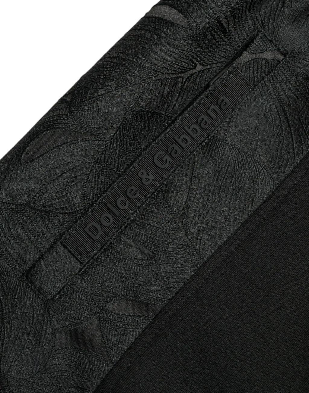 Pantalon jogger slim noir dolce gabbana en coton stretch avec motif feuille ton sur ton subtil