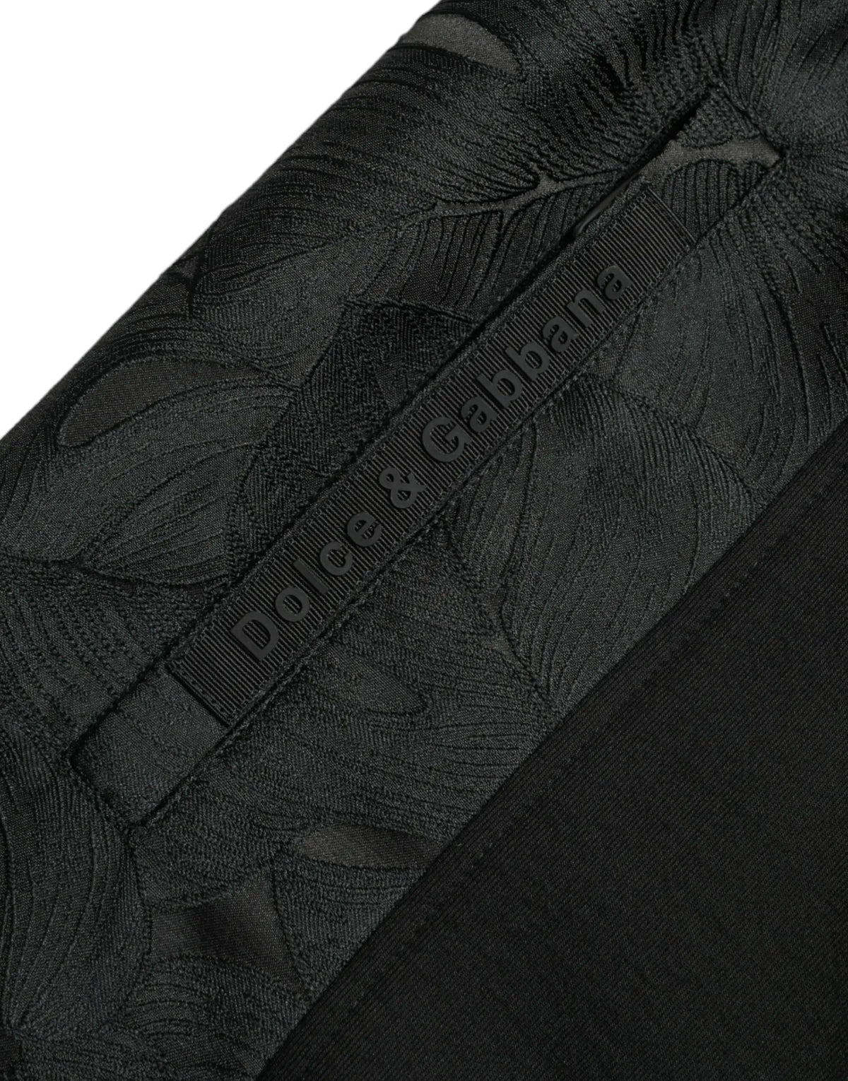 Pantalon jogger slim noir dolce gabbana en coton stretch avec motif feuille ton sur ton subtil