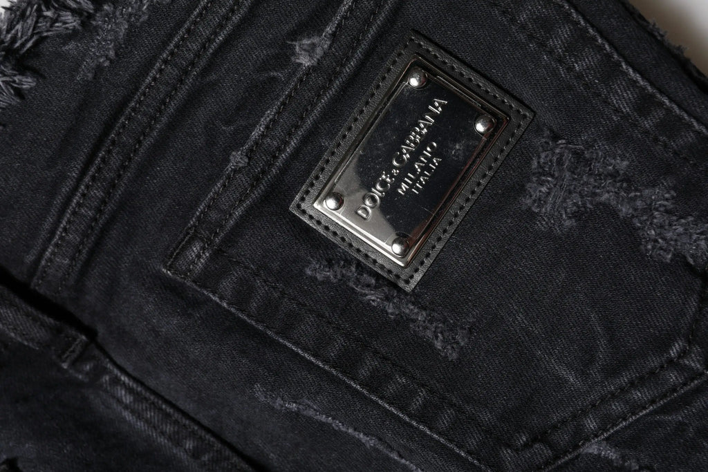 Jeans skinny en denim noir distressed en coton dolce gabbana avec patch métallique argenté rectangulaire au dos