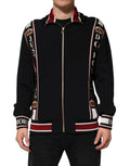 Dolce & Gabbana sweat zippé noir avec bandes rouges et blanches, zippers dorés et couronnes brodées sur les manches