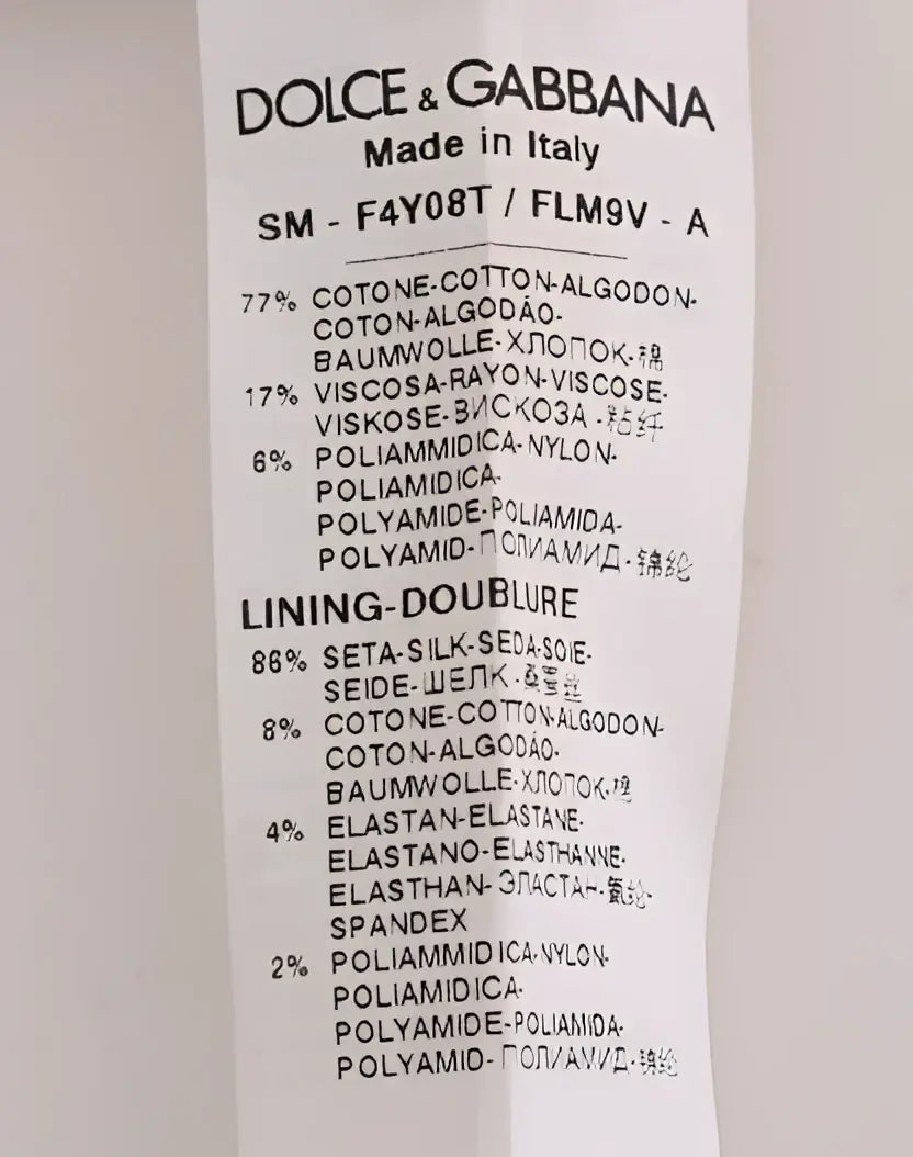 Étiquette dolce & gabbana indiquant la composition du tissu pour une jupe noire florale en dentelle a-line fabriquée en italie