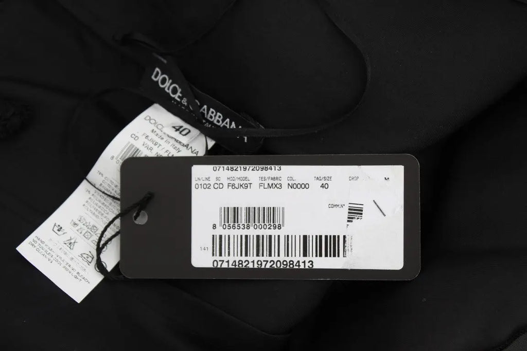 Étiquette noire dolce and gabbana avec label blanc et code-barres sur robe droite noire en dentelle florale