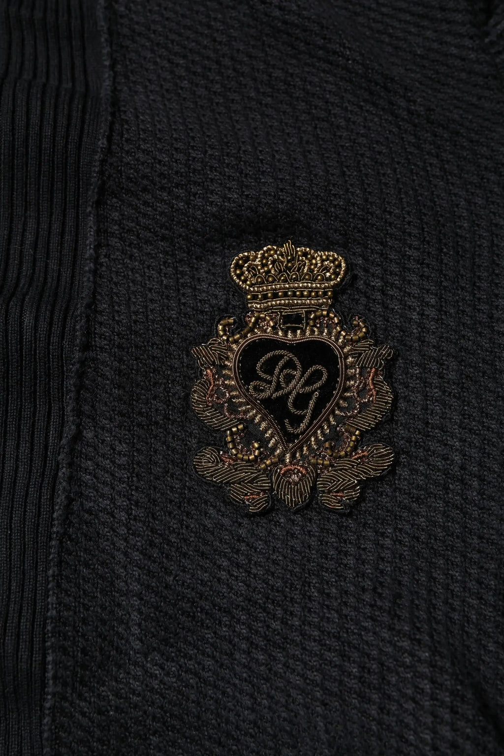 Pull noir en velours côtelé dolce & gabbana avec un écusson brodé or orné d’une couronne et d’un monogramme en forme de cœur