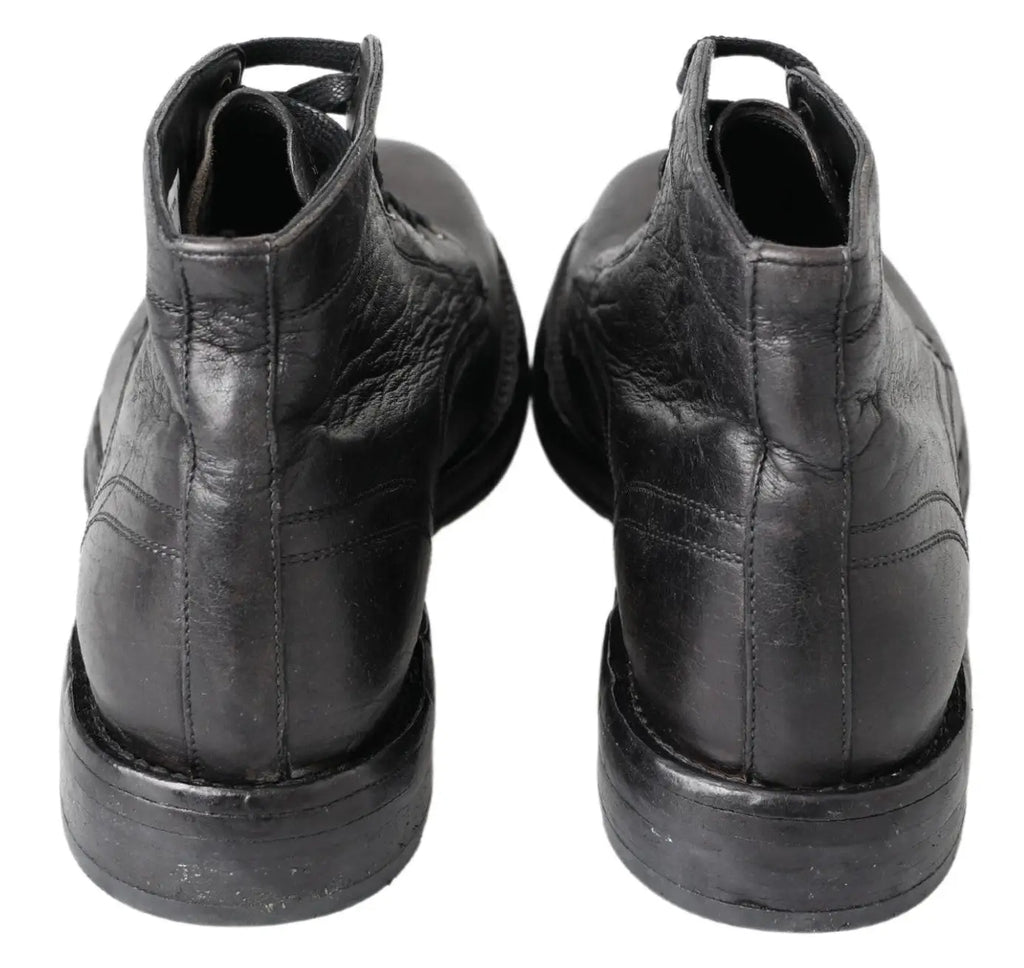 Bottes noires en cuir horse perugino dolce & gabbana avec coutures apparentes et texture légèrement usée