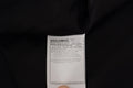 Étiquette noire dolce & gabbana avec texte blanc et composition détaillée du tissu pour veste blazer martini 2 pièces