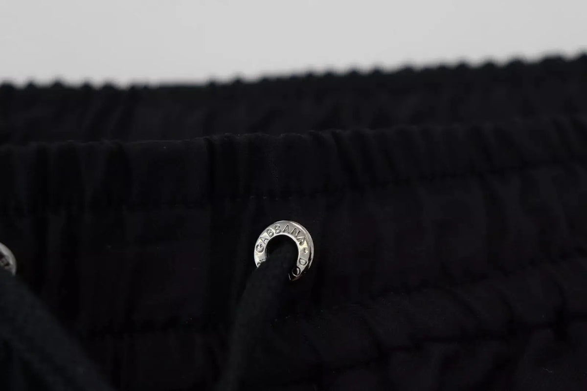 Anneau en métal argenté avec dolce & gabbana gravé attaché à tissu noir du pantalon jogging en laine noir dolce & gabbana