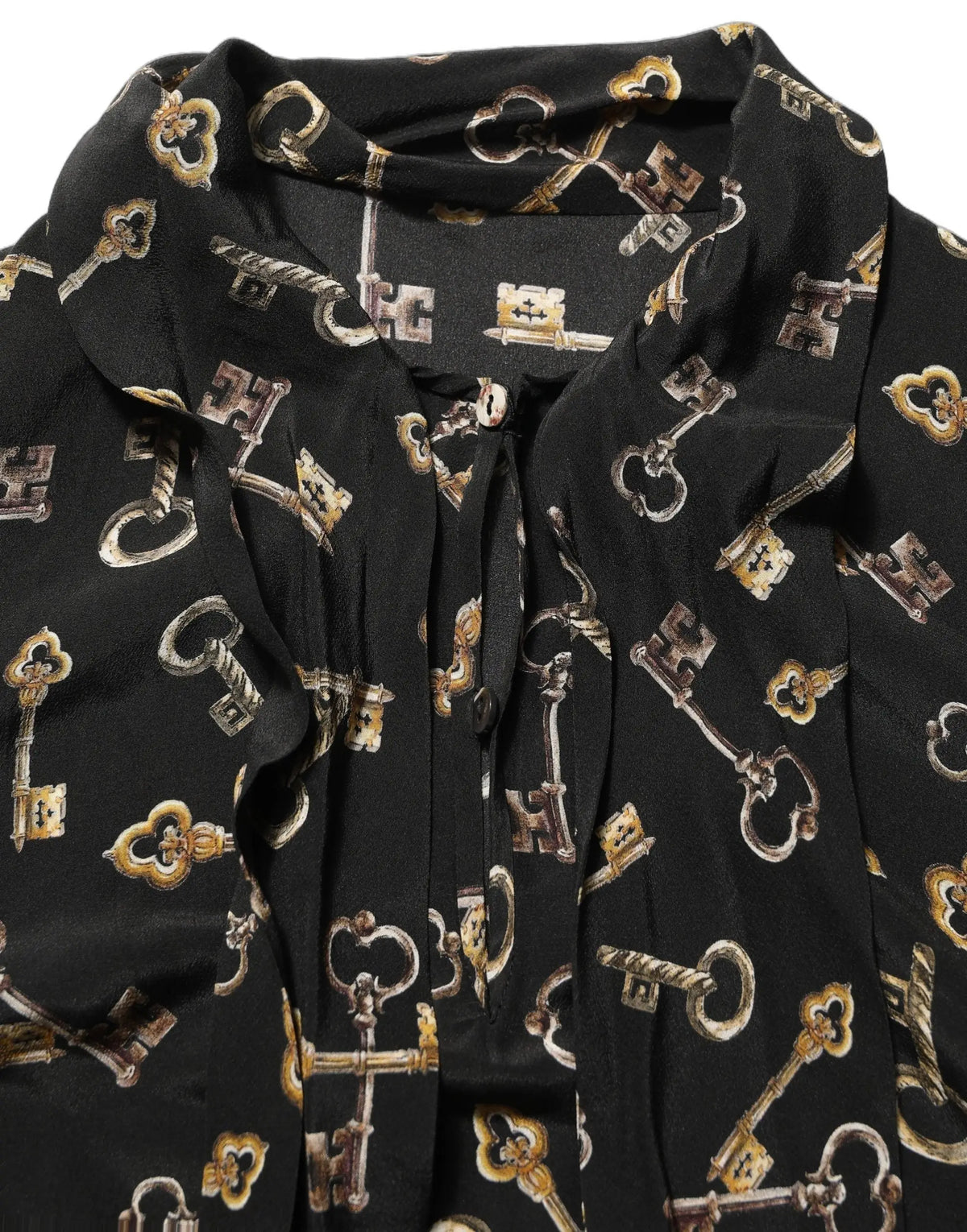 Blouse noire dolce & gabbana en soie avec imprimé de clés vintage dorées et métalliques et col lavallière
