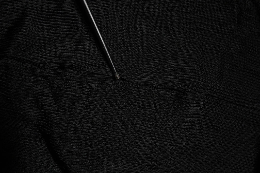Black textured knit fabric with a slender metallic tool on dolce & gabbana black knit long sleeves turtleneck slim top