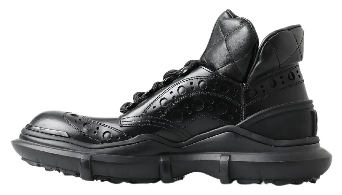 Bottes noires en cuir dolce & gabbana à cheville avec col matelassé, détails brogue et semelle épaisse en caoutchouc