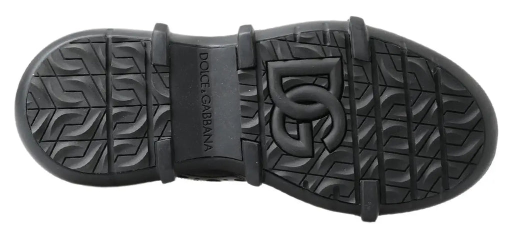 Semelle en caoutchouc noire avec logo dolce gabbana embossé et motif antidérapant pour bottines en cuir noir