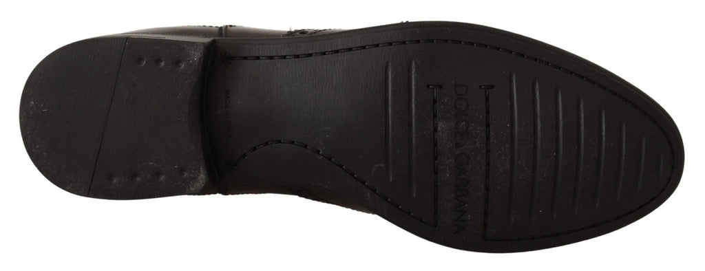 Semelle de bottines plates noires en cuir noir dolce gabbana avec motif antidérapant et logo embossé