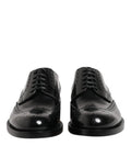 Dolce & gabbana derby wingtip noirs en cuir verni avec perforations détaillées pour usage formel