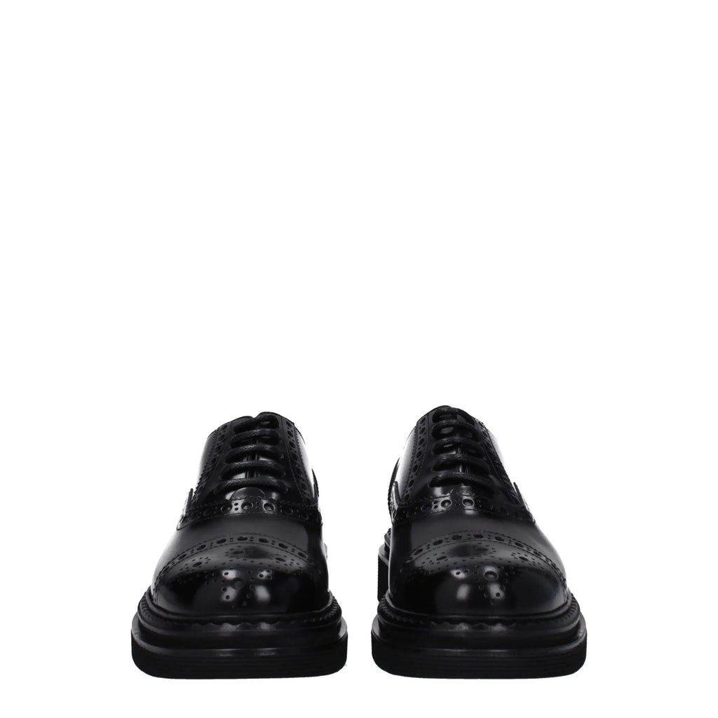 Dolce & gabbana black leather brogue oxford shoes with glossy patent finish and detailed perforated patterns