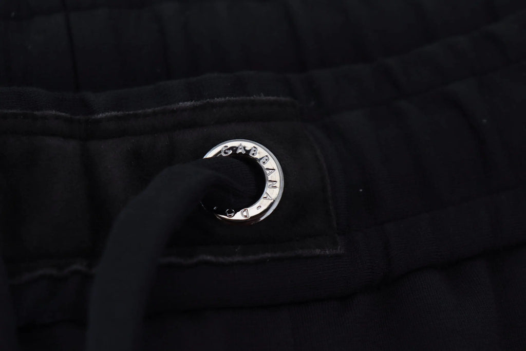 Grommet en métal argenté dolce & gabbana avec logo gravé sur tissu matelassé noir de pantalon de sport en laine homme