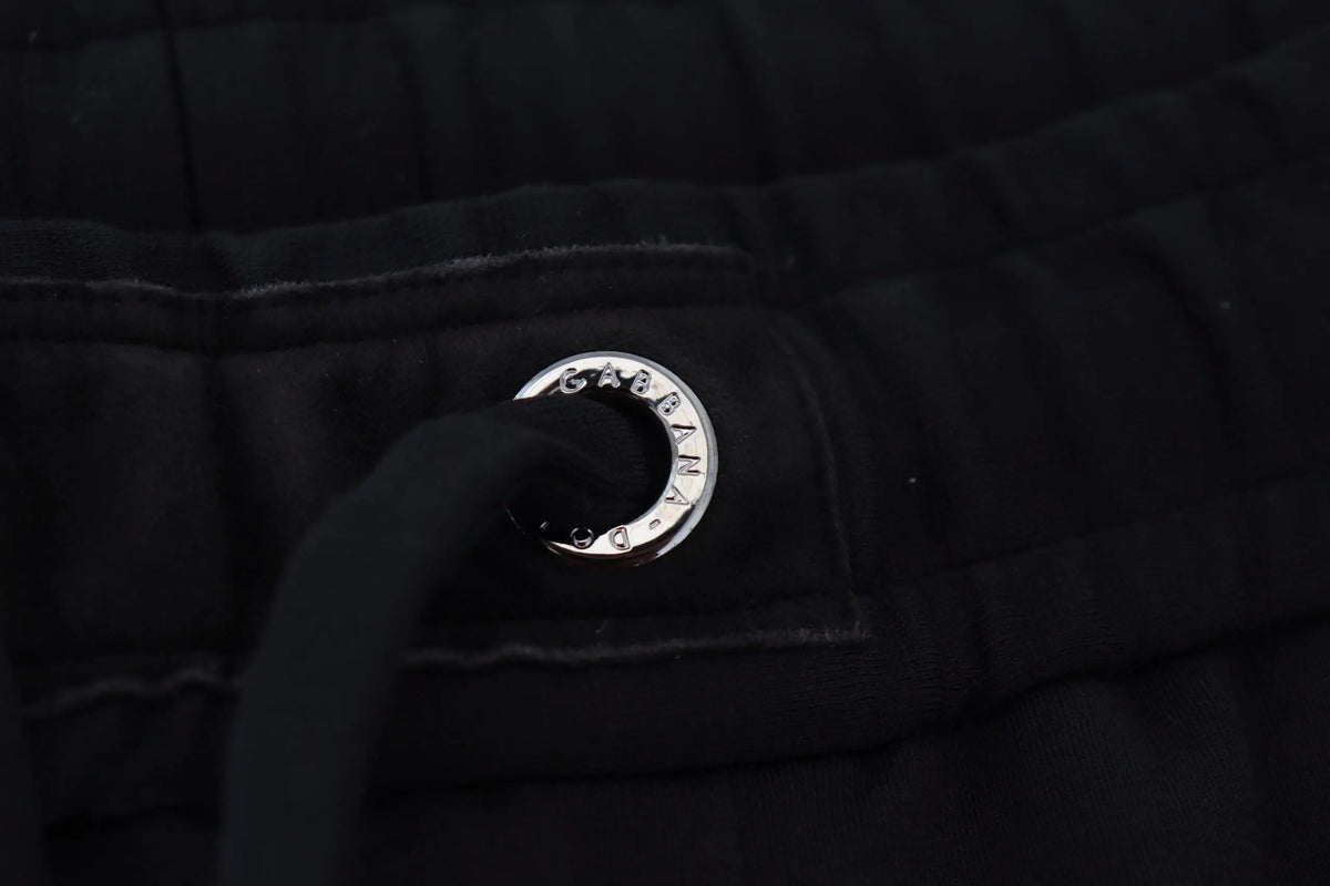 Grommet en métal argenté dolce & gabbana avec logo gravé sur tissu matelassé noir de pantalon de sport en laine homme