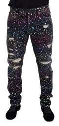 Jean en denim noir dolce & gabbana avec imprimé multicolore éclaté et détails déchirés usés