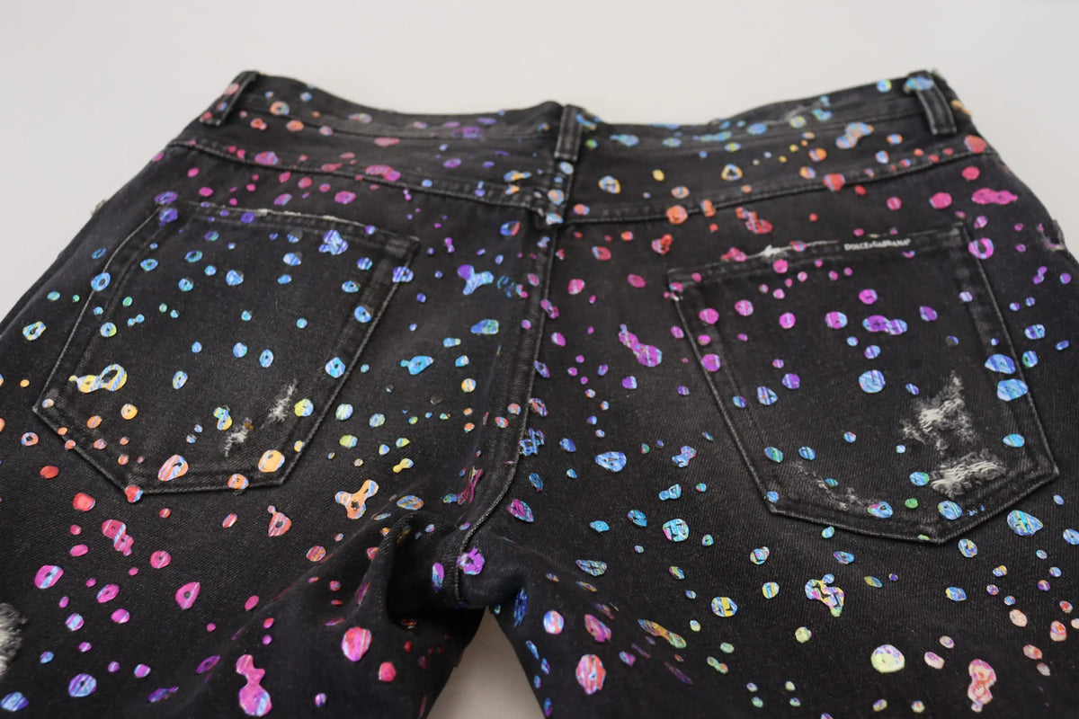 Jean denim noir dolce gabbana avec motif éclaboussures multicolores et aspect usé tattered