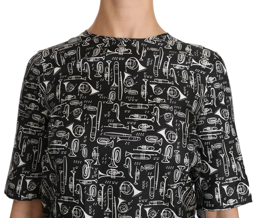 Blouse en soie noire dolce & gabbana avec illustrations blanches d’instruments de musique