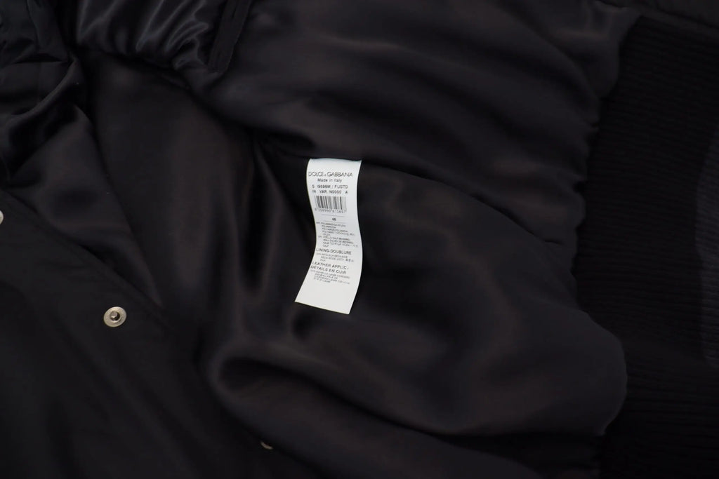 Intérieur de la veste dolce & gabbana noire en nylon avec tissu satin et bouton métallique crystalisé