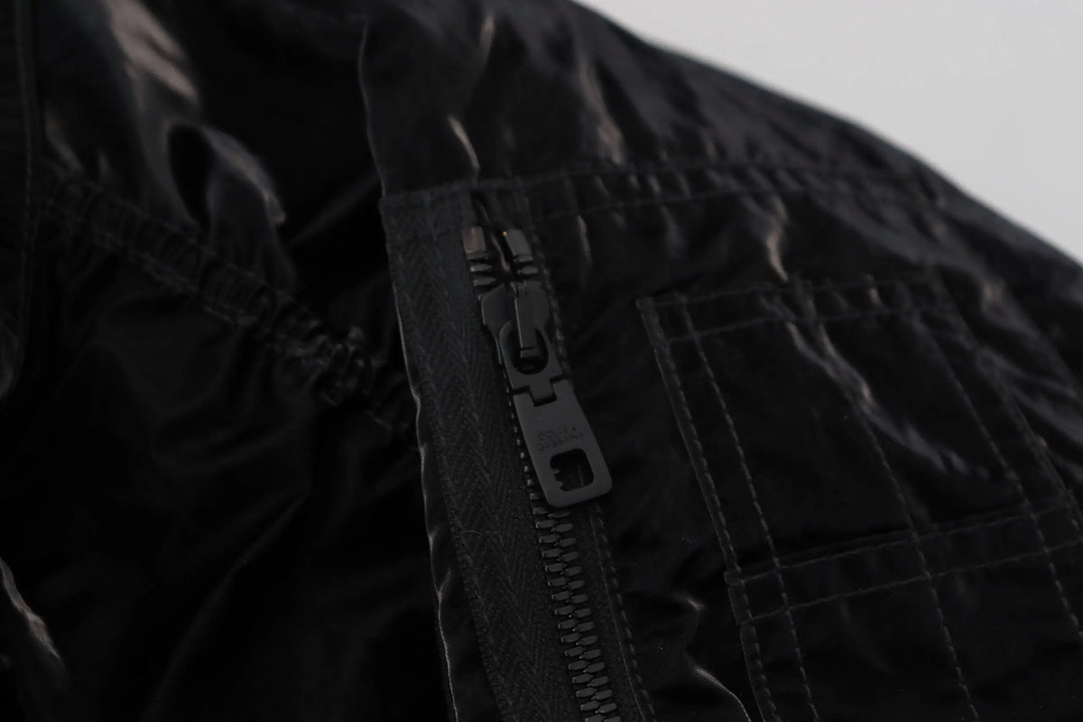 Fermeture éclair noire avec tirette métallique sur veste bomber matelassée noire en nylon à capuche dolce & gabbana