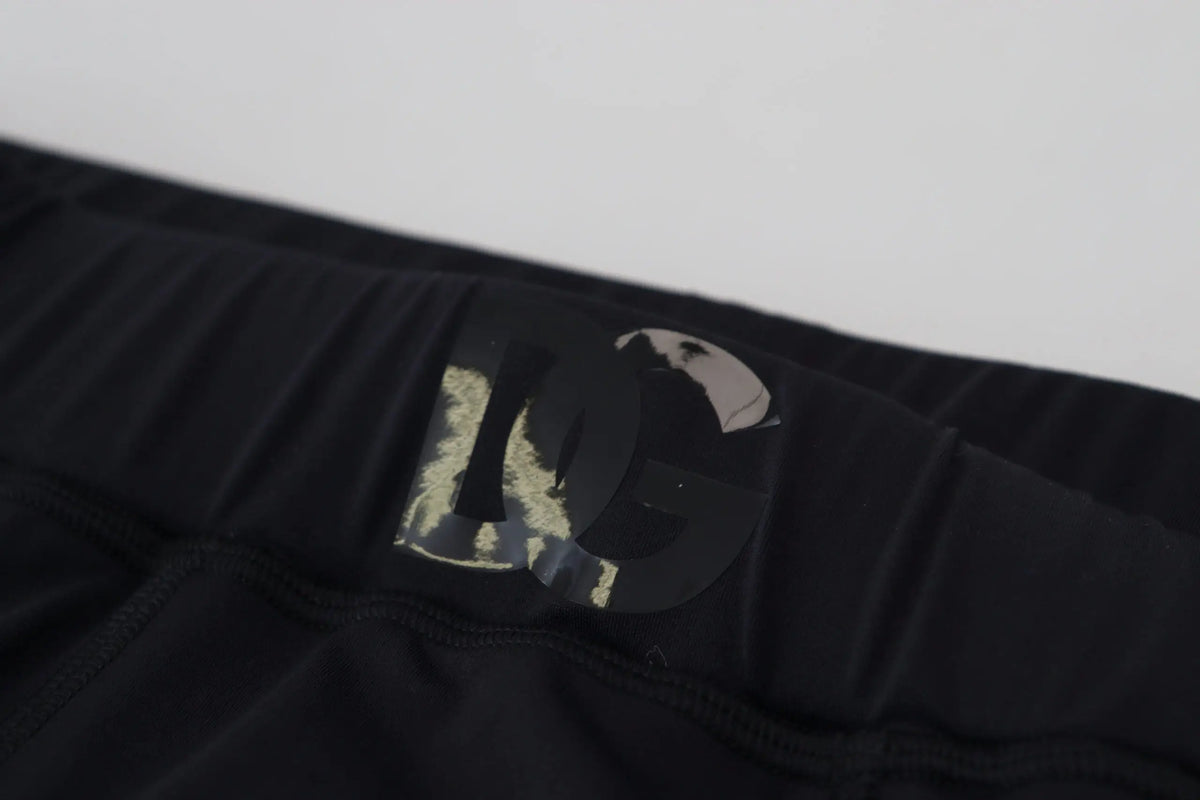 Patch logo dolce & gabbana noir avec détails en feuille d’or métallisée sur la ceinture d’un pantalon de sport nylon stretch slim fit