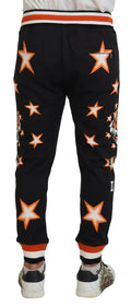 Pantalon de sport noir dolce & gabbana avec motifs étoiles orange et blanc, tigre sur le côté et bordures rayées