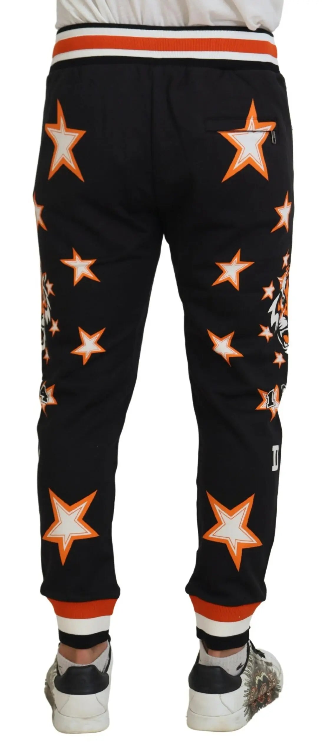 Pantalon de sport noir dolce & gabbana avec motifs étoiles orange et blanc, tigre sur le côté et bordures rayées