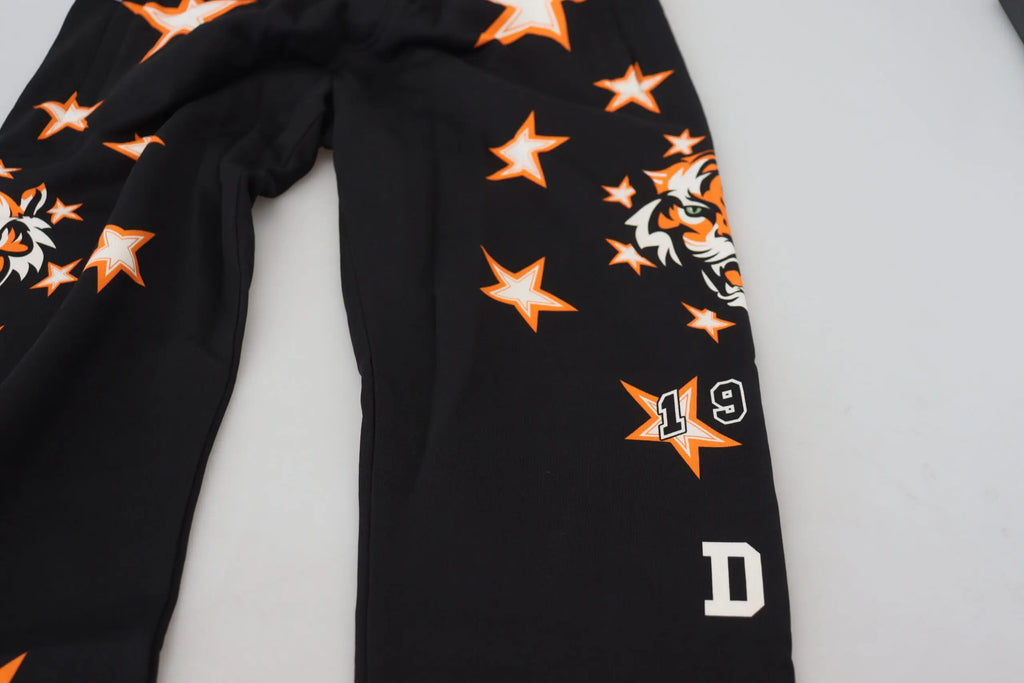 Pantalon de sport dolce & gabbana noir avec motif étoile orange, têtes de tigre blanches et chiffre 19 sur étoile orange